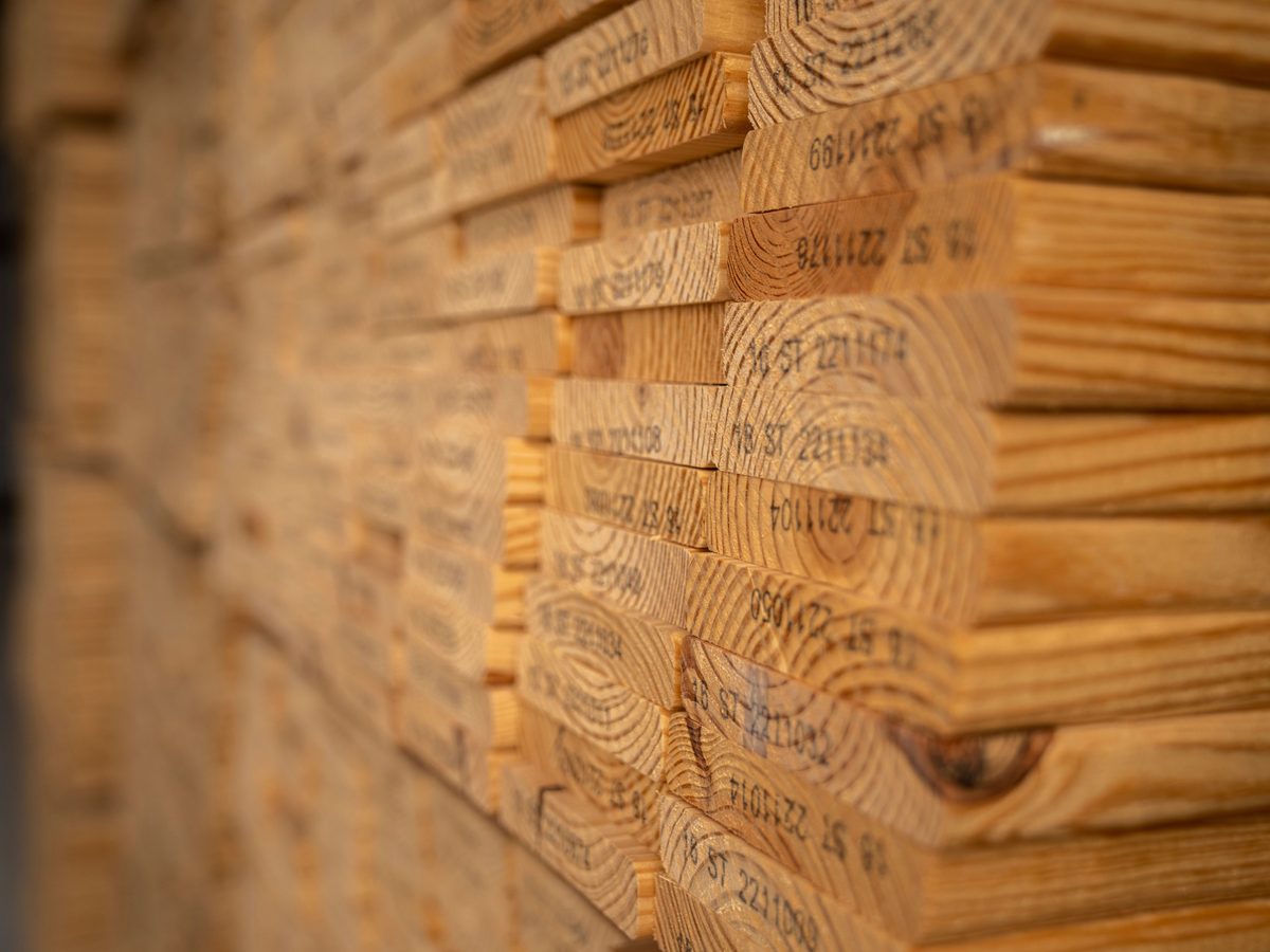 Stacked lumber ready for IGVbuild systems construction
