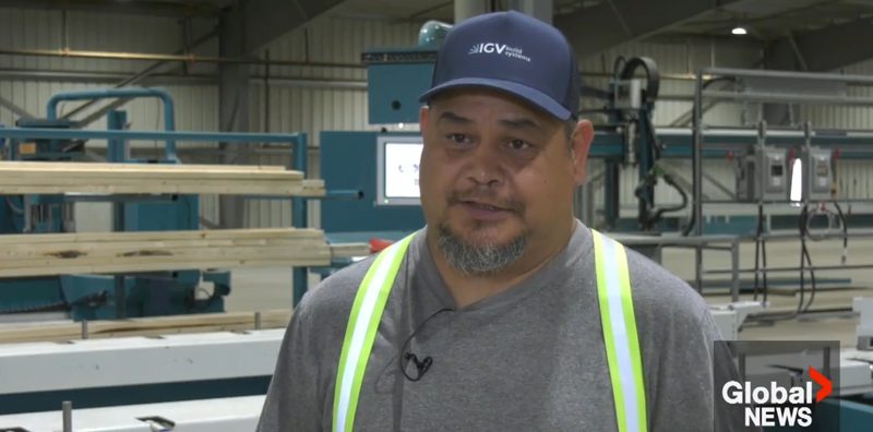 An IGVbuild systems worker wearing a company cap being interviewed on the manufacturing floor